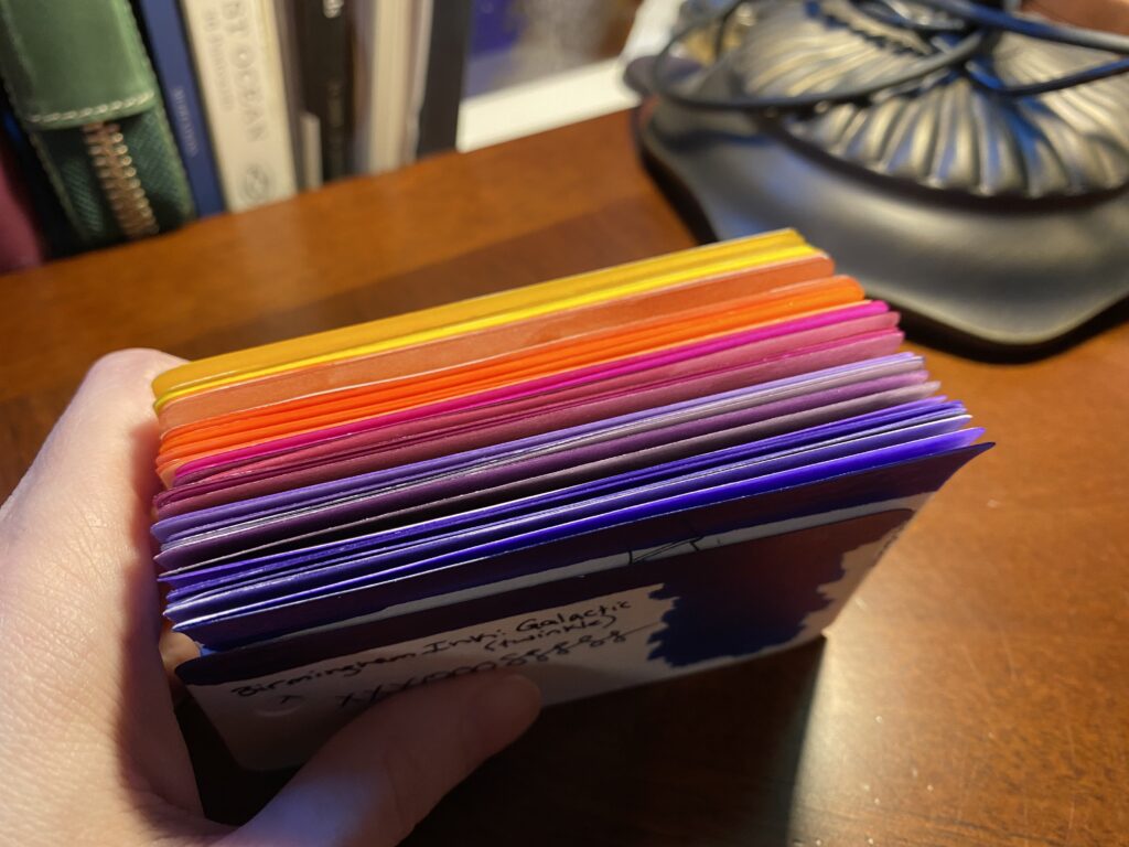 Seen from the top down, it's clear the top edges of each card has been colored as well. There is a nice range from yellows to oranges to magentas to purples. 