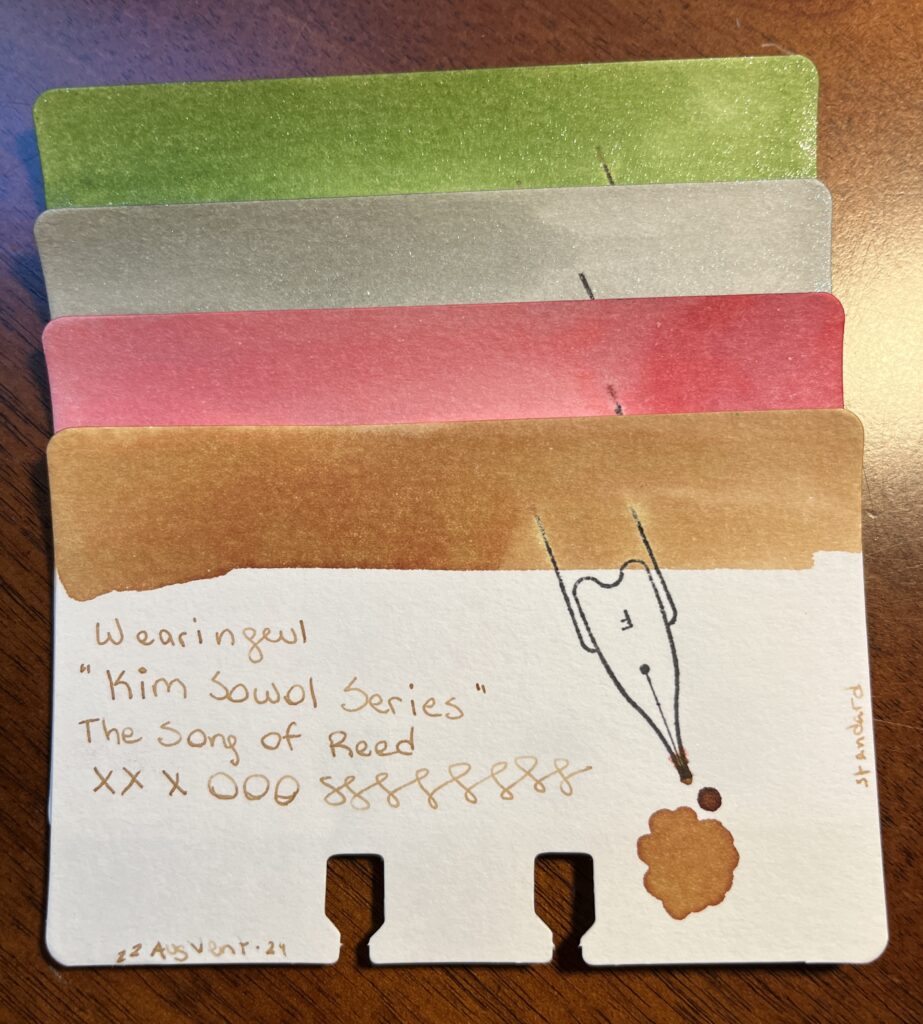 4 cards stacked on top of each other, the first 3 are only visible by the ink swabs at the top of the card. The bottom card is full visible and the text says:
Wearingeul 
“Kim Sowol Series”
The Song of Reed
Xxx ooo sssssss
22AugVent-24 is written along the edge of the bottom left hand corner, and standard is written along the right side edge of the card. 