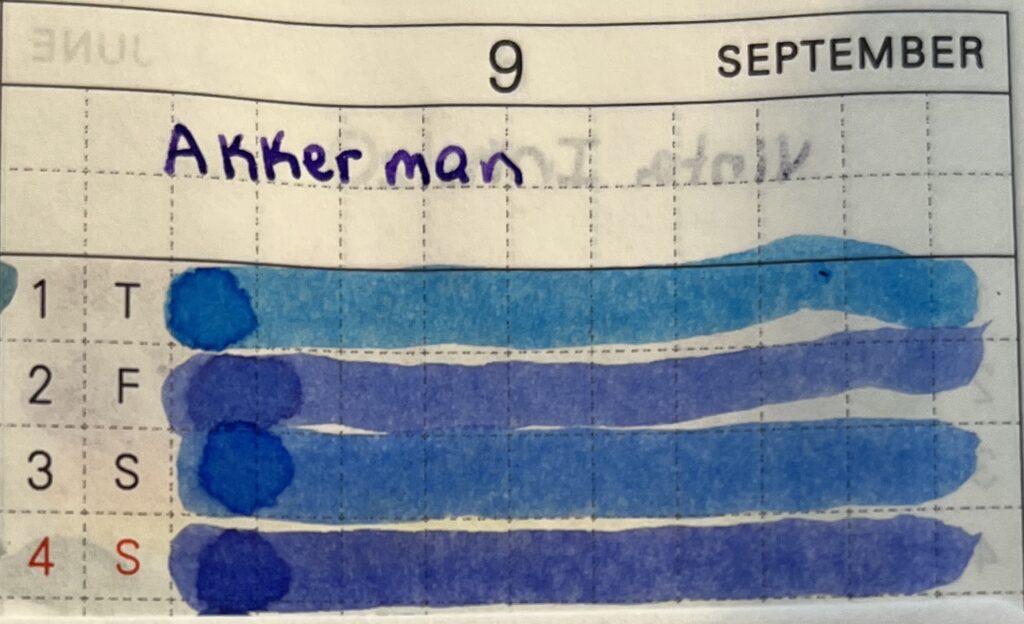 A close up of a page in a planner, each line with the day of the month to the left. At the top is “9” and “September,” underneath I have written Akkerman in purple. There are four days visible, each with a line of ink drawn from right to left - they are all different color blues. 