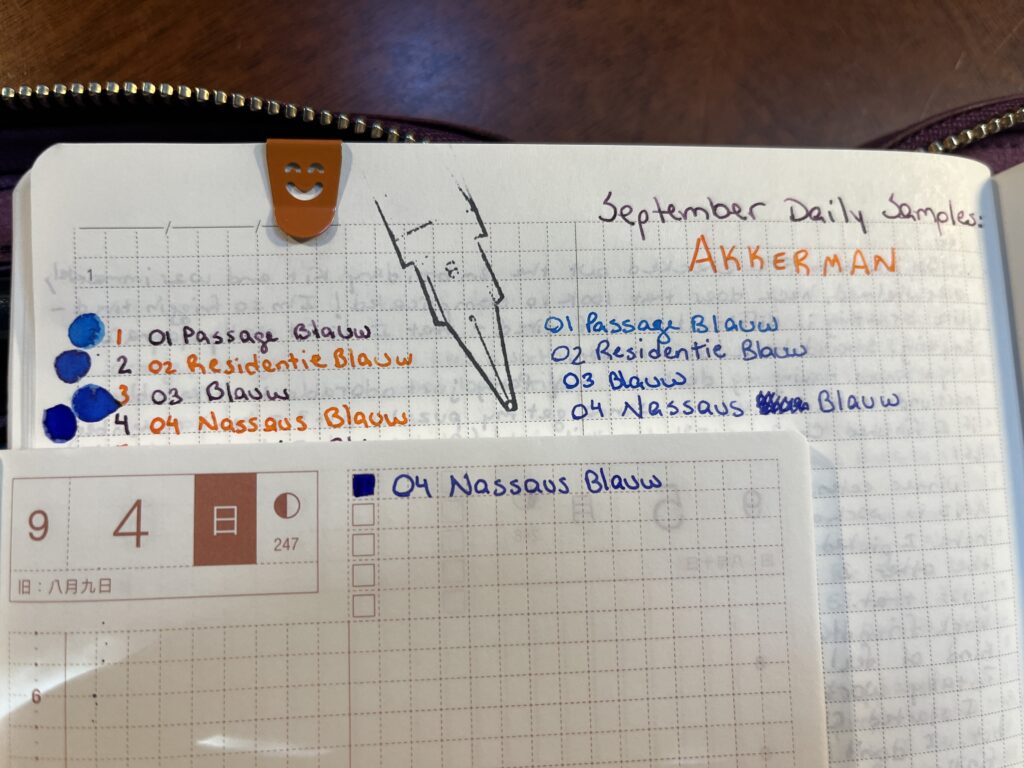 Two notebooks, the smaller planner resting on the larger. In the planner, you can see “04 Nassaus Blauw” and a square of the same color to the left. The larger notebook page is for September Daily Samples for Akkerman, with the first 4 ink names listed twice - once on the left in alternating orange and purple, and once on the right in that days ink color. There are drops of ink on the far left of that days ink.