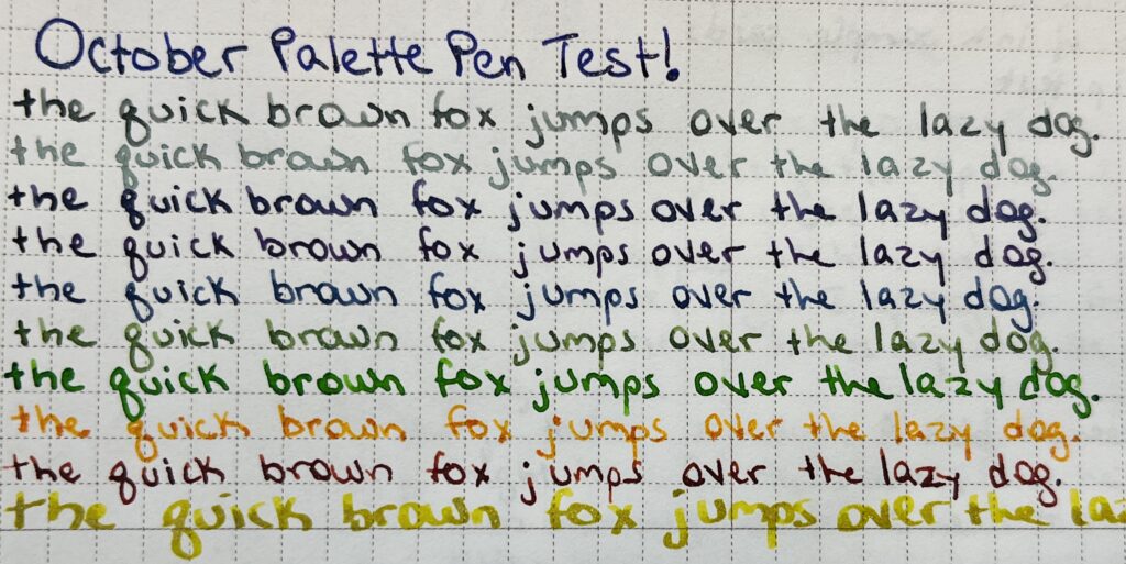 “October Palette Pen Test” in a dark purple ink. On the following lines “the quick brown fox jumps over the lazy dog.” Is written in 10 different color inks. Two grey, three purple, two green, one orange, one red, and one yellow. 