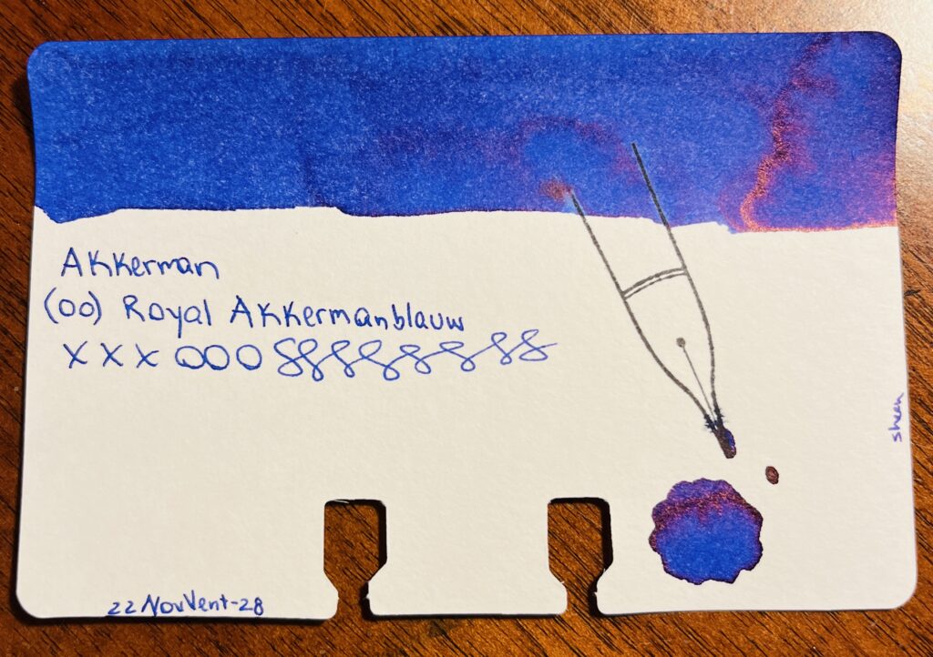 A single sample card, blue ink with a reddish sheen swatch on the top. The text says “Akkerman (00) Royal Akkermanblauw, xxxooosssssss and 22NovVent-28. On the right side of the card the text says “sheen” and there is a pool of ink below a stamp of a nib. 