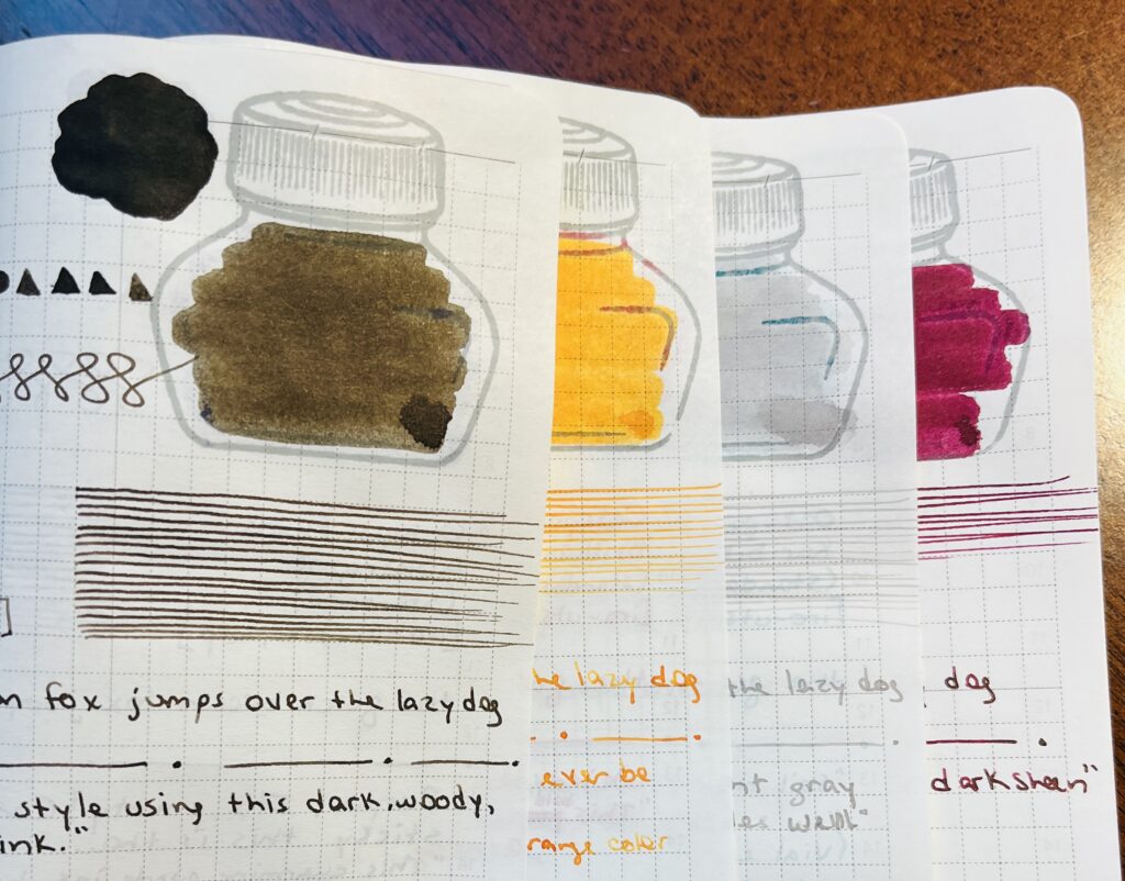 4 notebook pages overlapping each other, able to see just a portion of the bottom 3 pages, and more of the top page. There is a sepia brown, a yellow,a gray, and a maroon ink sampled with shapes, swirls, straight lines, smudges and writing. 