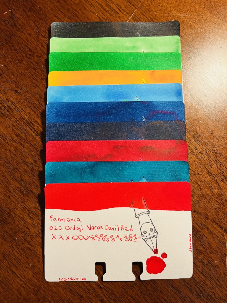 10 ink sample cards stacked on top of one another, so only the top of the card with the color swatch on it is visible on all of the cards except the bottom one. The bottom cards says “Pennonia 020 Ordogi Voros Devil Red xxxooossssss 22OctVent-20 standard”